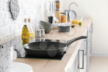 Frying pan on electric stove in kitchen�