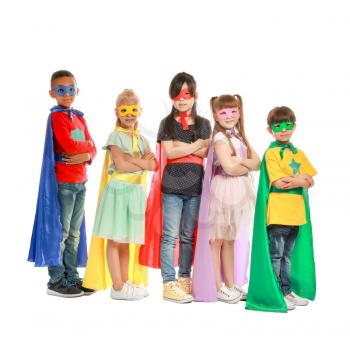 Cute little children dressed as superheroes on white background�