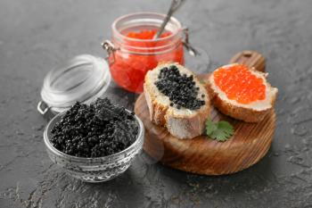 Sandwiches with delicious caviar on dark background�