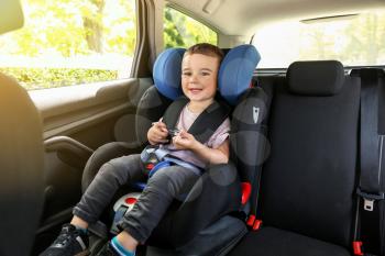 Baby boy buckled in car seat�
