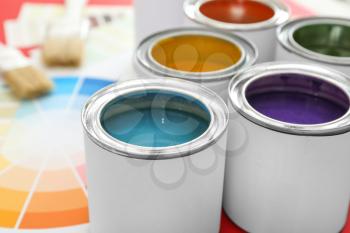 Cans of paints on table�
