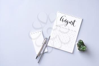 Flip paper calendar and notebook on light background�