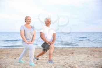 Sporty mature couple training at sea resort�