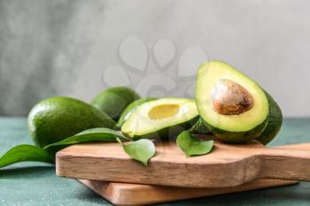 Boards with fresh ripe avocados on table�
