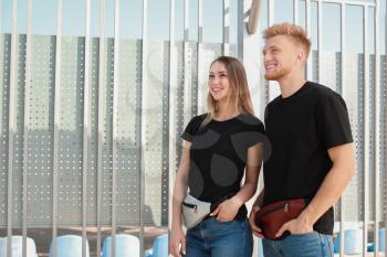 Man and woman in stylish t-shirts outdoors�
