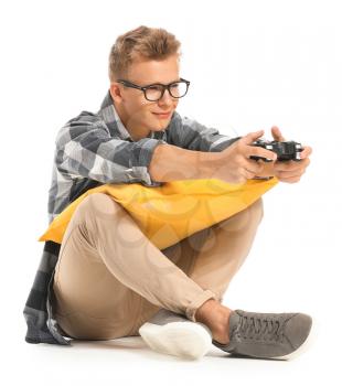 Teenage boy playing video game on white background�