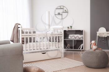 Interior of modern baby room with crib�