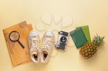 Composition with world map, shoes, photo camera, passports and pineapple on light background�