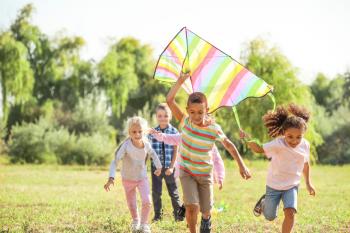 Group of happy children with kite in park�