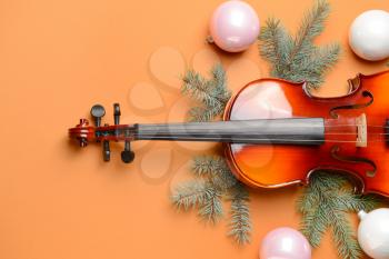 Violin and Christmas decor on color background�