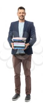 Handsome male teacher with books on white background�
