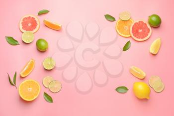 Different sliced citrus fruits on color background�
