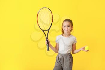 Little girl with tennis racket and ball on color background�