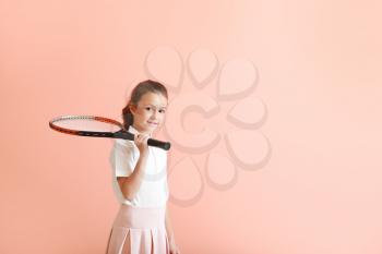 Little girl with tennis racket on color background�