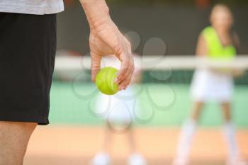 Young man playing tennis on court, closeup�