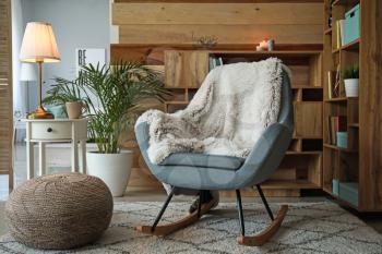 Cozy rocking chair in interior of living room�