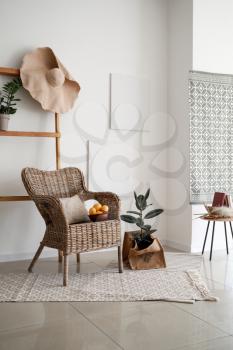 Interior of light room with wicker armchair�