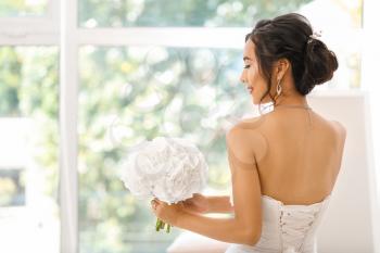 Beautiful young Asian bride near window�