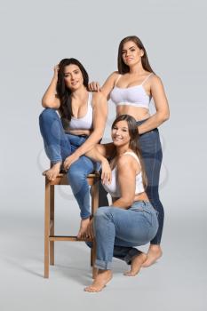 Group of body positive women on grey background�