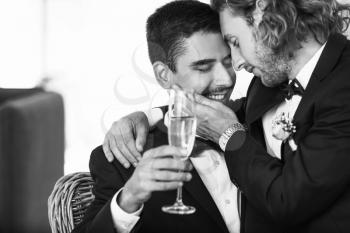 Black and white portrait of happy gay couple on their wedding day at home�