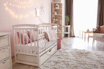 Interior of stylish children's room with baby bed�