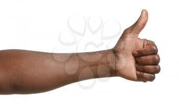Hand of African-American man showing thumb-up gesture on white background�