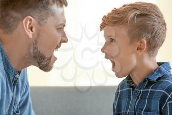 Father and his little son arguing at home�