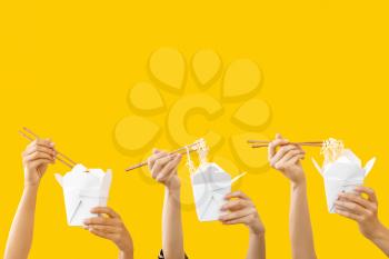 Many hands with Asian food on color background�