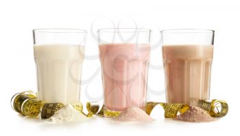 Glasses of different protein shakes on white background�