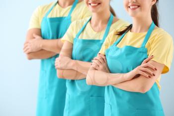 Team of janitors on color background�