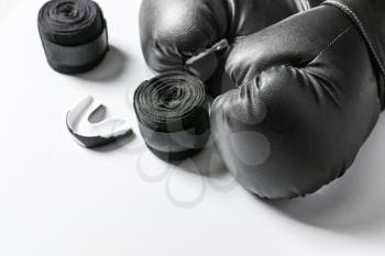 Boxing gloves, wrist bands and mouth piece on white background�