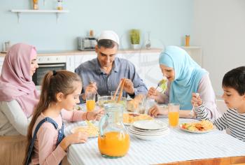 Muslim family having dinner at home�