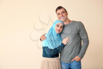 Portrait of Muslim couple on light background�