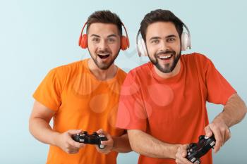 Friends playing video game on color background�