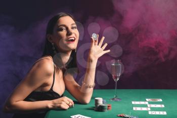 Female poker player at table in casino�