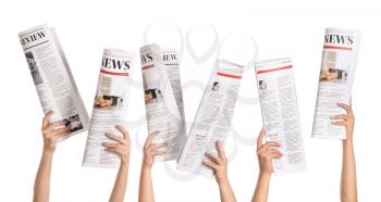 Female hands with newspapers on white background�