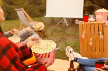 Friends watching movie in outdoor cinema�