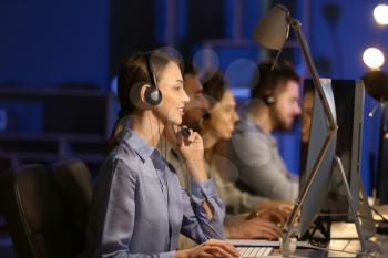 Technical support agents working in office at night�