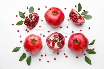 Ripe tasty pomegranates on white background�