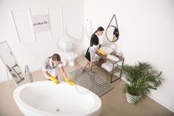 Beautiful chambermaids cleaning hotel bathroom�