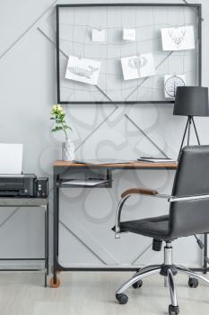 Stylish comfortable workplace with moodboard in modern room�