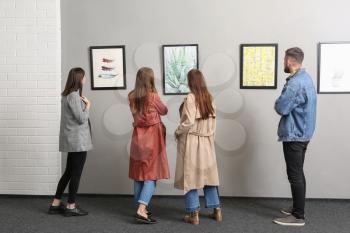 People at exhibition in modern art gallery�