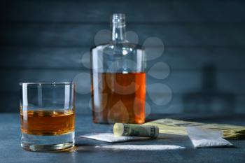 Alcohol, drugs and money on table. Concept of bad habits�