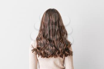 Young woman with beautiful hair on light background�