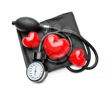 Sphygmomanometer with red hearts on white background�