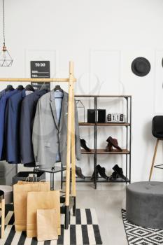 Interior of modern dressing room with stylish male clothes�