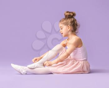 Cute little ballerina on color background�