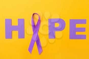 Violet ribbon and word HOPE on color background. Domestic violence concept�