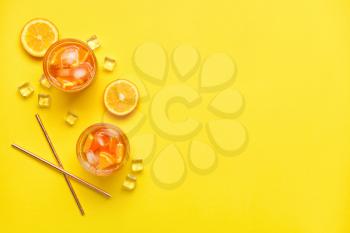 Glasses of tasty cold ice tea on color background�