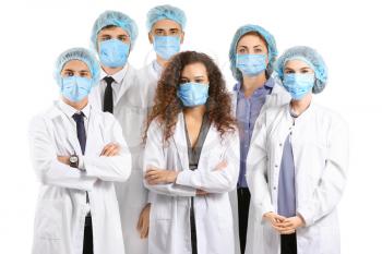Group of doctors with protective masks on white background. Concept of epidemic�